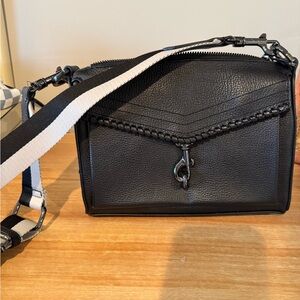 Stylish Black Crossbody Bag with Striped Strap